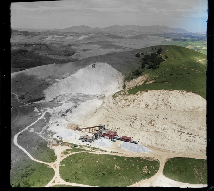 Portland Cement Works limestone quarry with earth digging equipment and railway, Northland