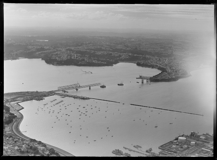 Original photograph: Auckland Harbour Bridge under construction, including Westhaven Marina and Northcote in the distance