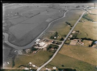 View of the Awanui River, Dairy Factory, Primary School and the Far North Road (State Highway 1F) surrounded by farmland, Northland Region
