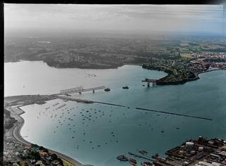 Auckland Harbour Bridge under construction, including Westhaven Marina and Northcote in the distance